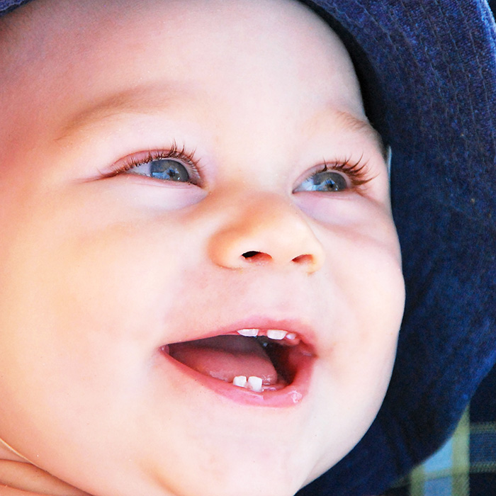 smiling baby with teeth