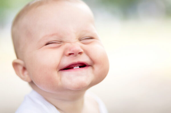 Smiling baby with teeth