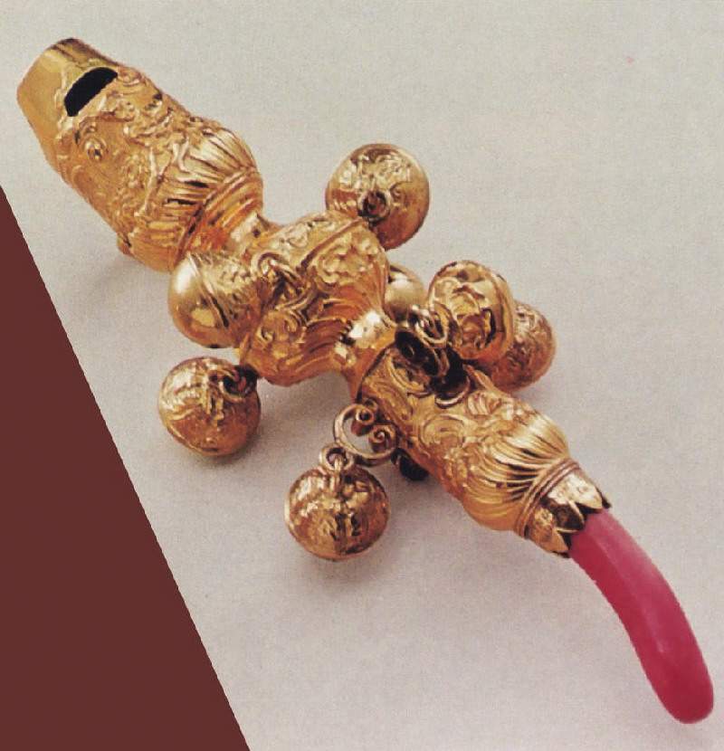 ancient pacifier made of gold and coral