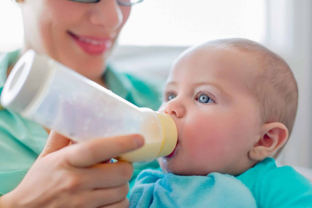 bottle feeding baby using paced feeding